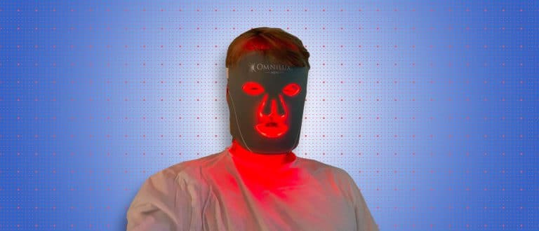 Man wearing omnilux mask on blue background
