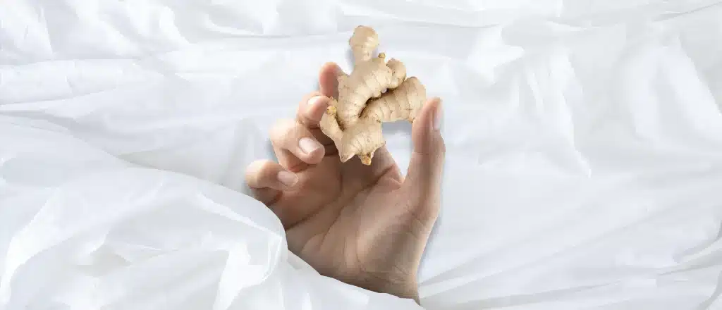 Man holds a piece of ginger under the covers | Ginger Benefits Sexually