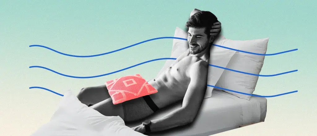 Man shirtless in bed, smiling