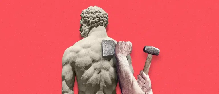 man chiseling marble sculpture's back