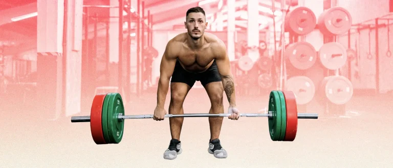 deadlifting with reverse grip shirtless on red background