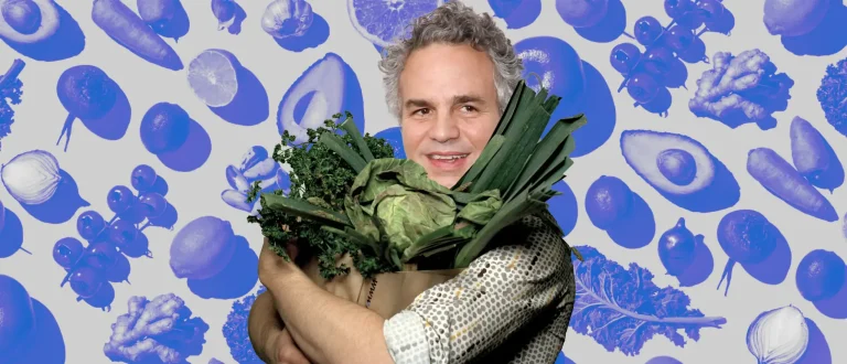 Mark Ruffalo carrying a big grocery bag of green veggies.