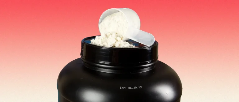 protein powder in black plastic tub