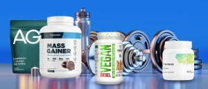 A few of the best post-workout supplements including AG1, Transparent Labs Mass Gainer, and Thorne Creatine in front of free weights on a blue background.