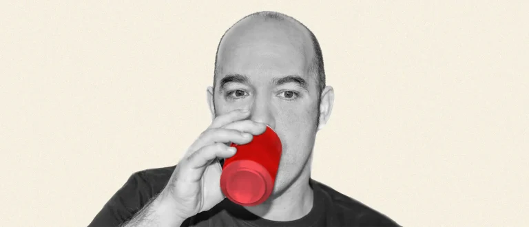 bald man drinking energy drink