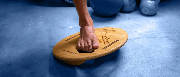 Man balancing barefoot on a mobo board