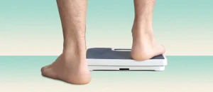 Man stepping onto a scale