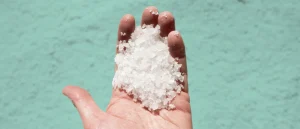 A man's hand holding salt
