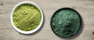 Chlorella and Spirulina in bowls on wooden table