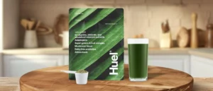 huel greens powder bag on counter with glass