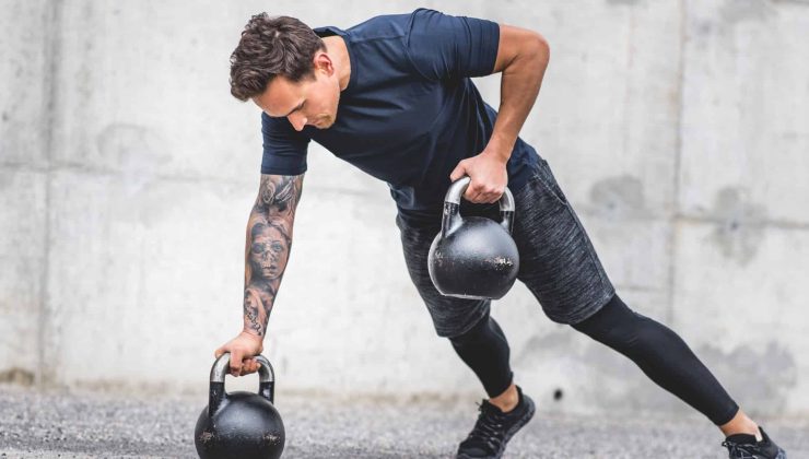 Man doing exercise with kettlebells